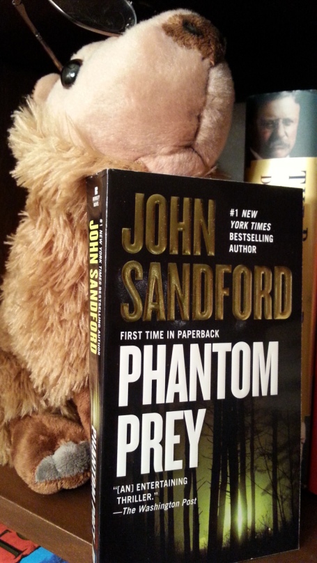 Stu the Reading Capybara with John Sandford's Phantom Prey